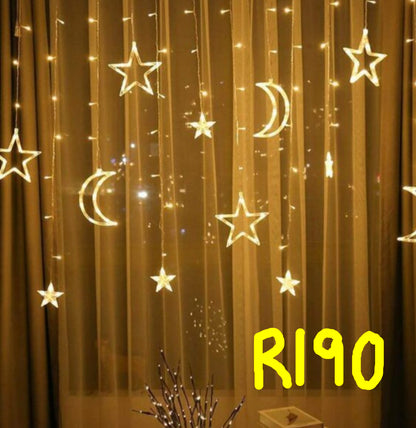 Decorative string lights shaped like stars and moons on a curtain